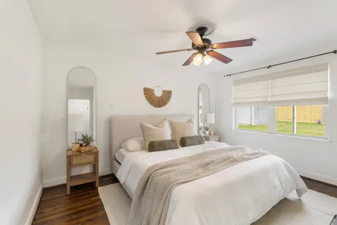a bedroom with a bed and a chandelier