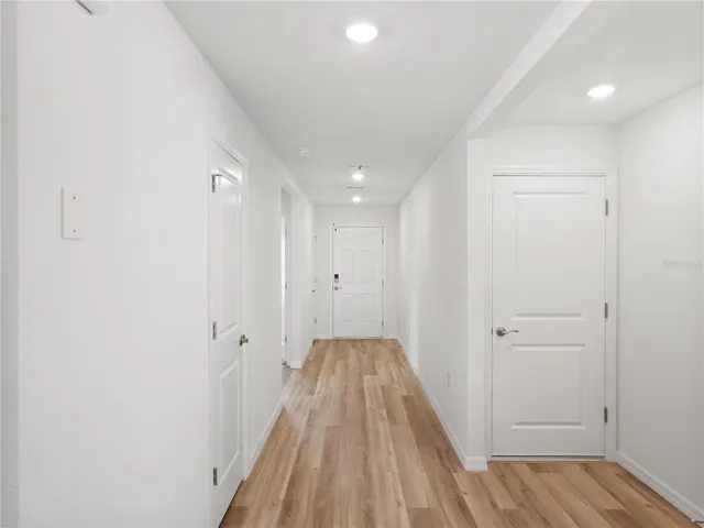 a view of a room with wooden floor and staircase