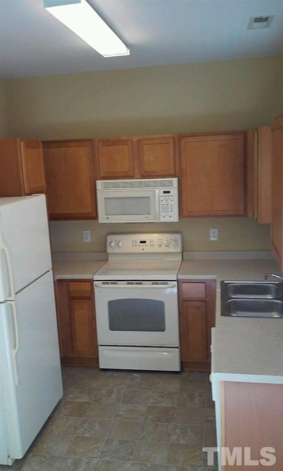 2132 Persimmon Ridge Drive Raleigh, NC 27604 - Photo 4 of 25 Upgraded wood cabinets in this lovely kitchen! All appliances stay! New Sink! You'll love this house!