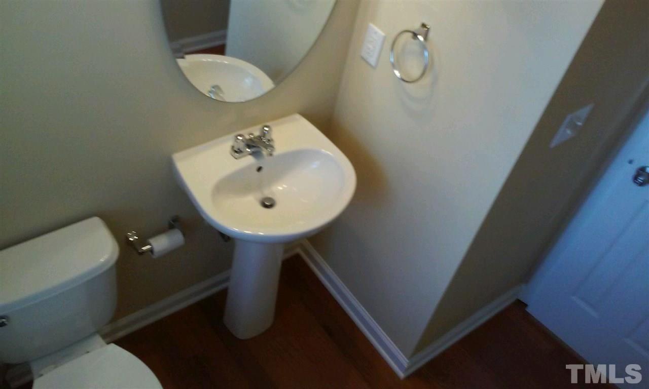 2132 Persimmon Ridge Drive Raleigh, NC 27604 - Photo 10 of 25 Powder room on first floor has hardwood floors and pedestal sink!
