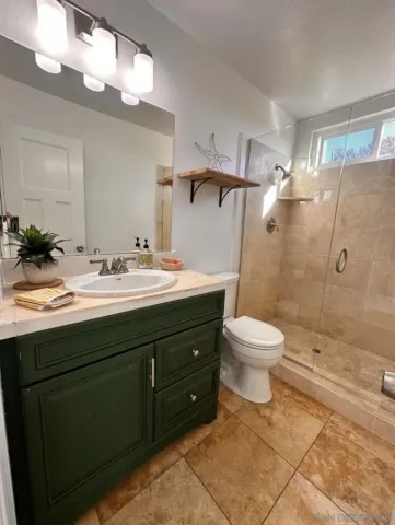 a bedroom with a bed painting on wall and a large window