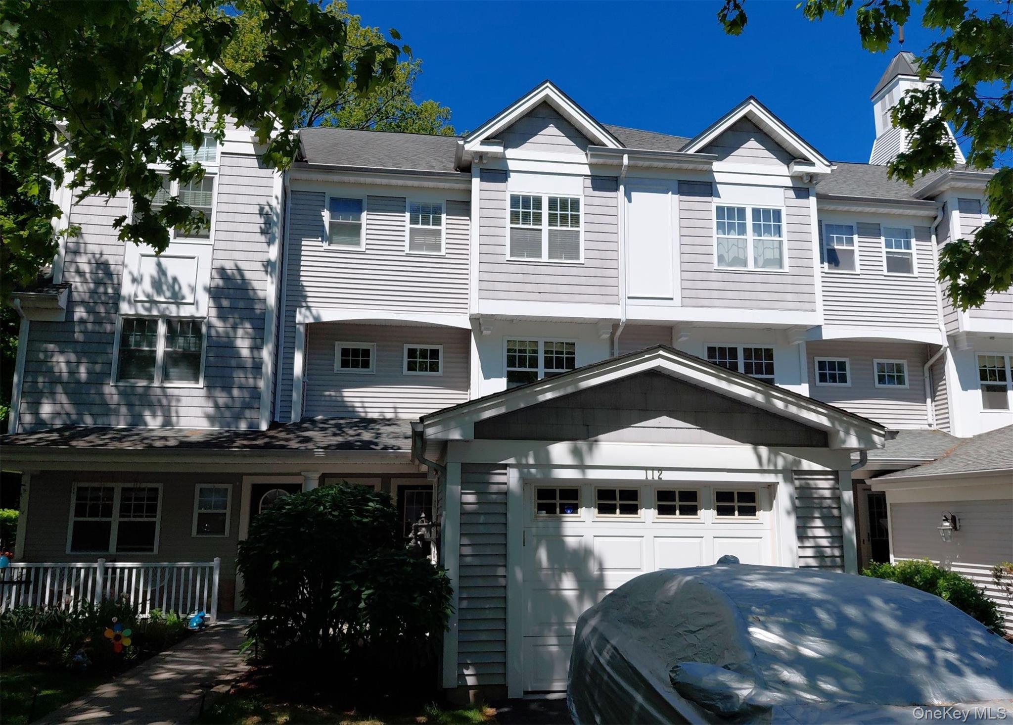 112 Riverbend Drive, Unit 88 Peekskill, NY 10566 - Photo 2 of 4 a front view of a residential apartment building with a yard