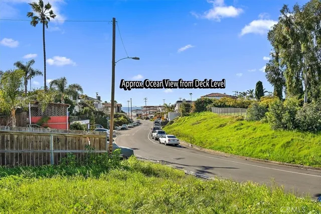 a backyard of a house with plants and large trees