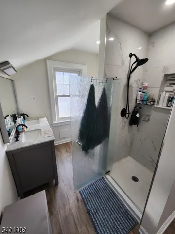 a bathroom with a sink a mirror and shower