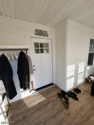 a view of a livingroom with furniture and floor to ceiling window