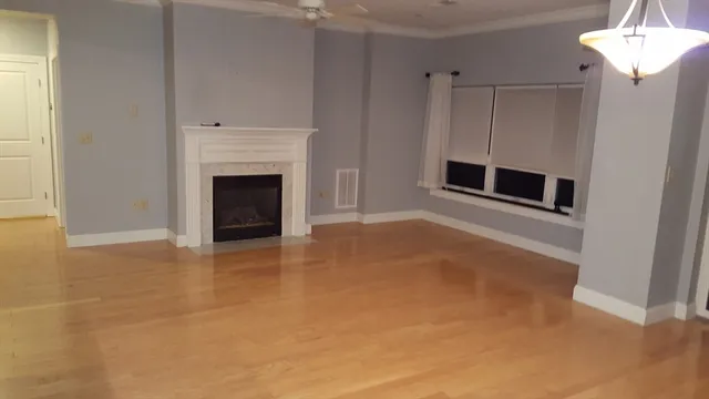 a view of a livingroom with a fireplace and window