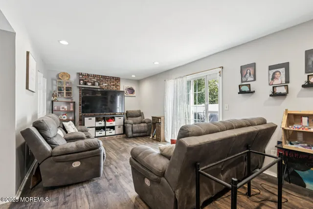 a kitchen with stainless steel appliances kitchen island granite countertop a table chairs and a refrigerator