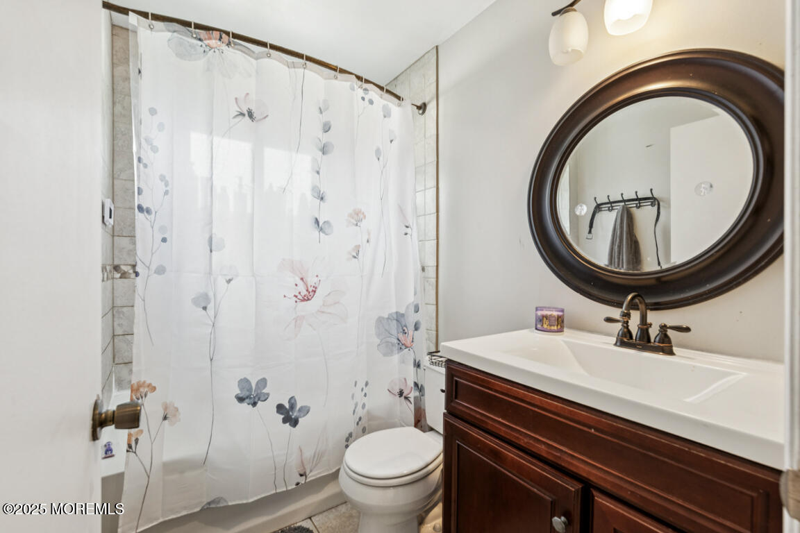 9 Cove Court Howell, NJ 07731 - Photo 15 of 20 a bathroom with a sink a toilet and a mirror