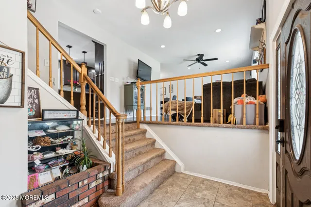 a view of entryway and hall with wooden floor
