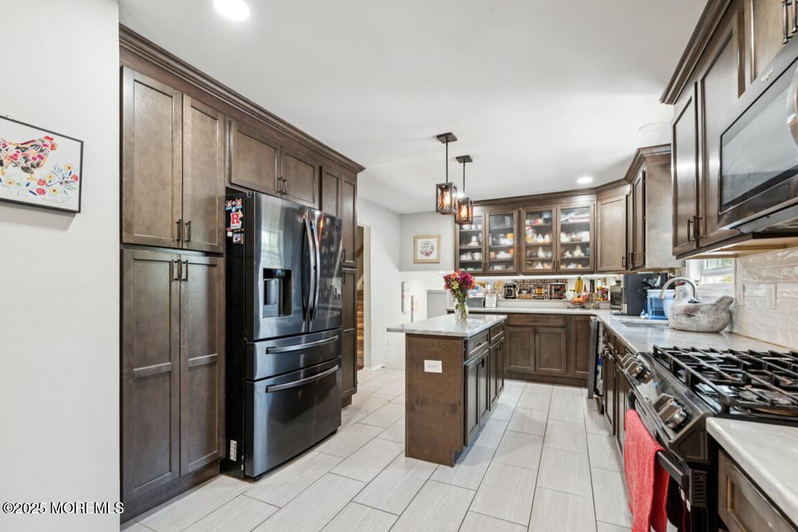 9 Cove Court Howell, NJ 07731 - Photo 9 of 20 a kitchen with stainless steel appliances granite countertop a refrigerator a stove and a sink