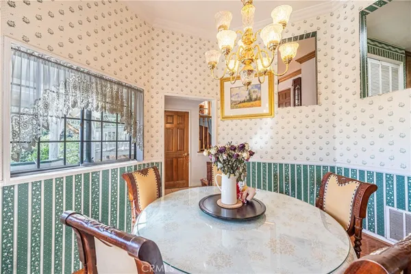 a dining room with furniture and a potted plant