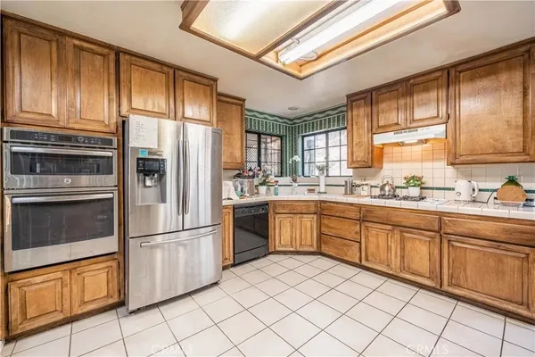 a kitchen with stainless steel appliances granite countertop a refrigerator and sink