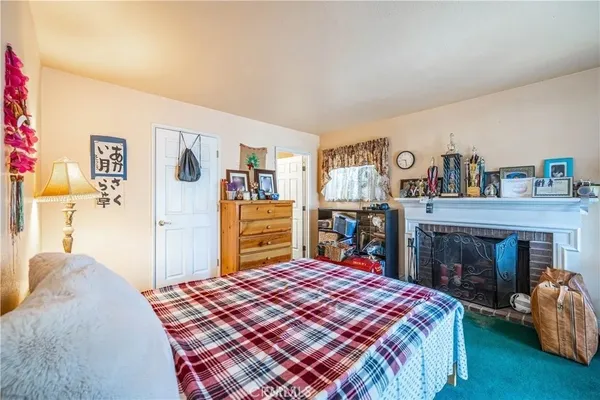 a bedroom with a bed and a fireplace