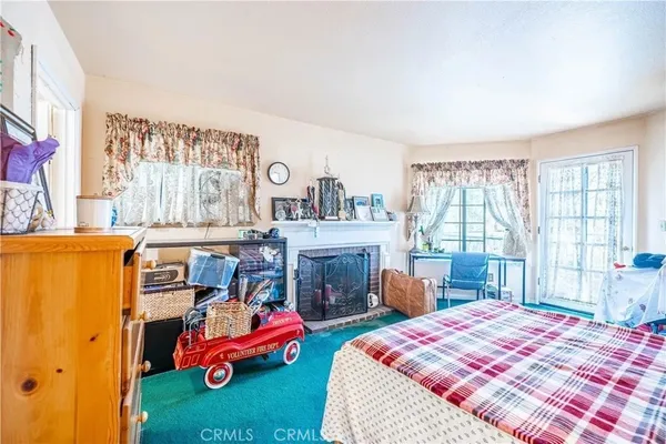 a bedroom with furniture and a fireplace