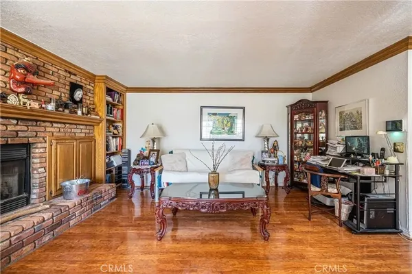 a living room with furniture dining area and a fireplace