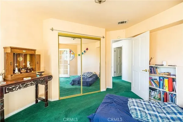 a bedroom with furniture and a book shelf