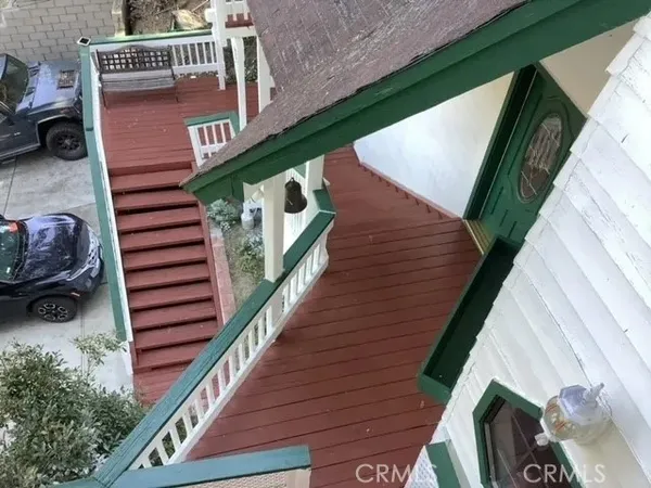 a hallway with a couch a fireplace with wooden floor