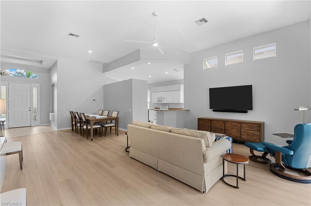 1717 Winding Oaks Way Naples, FL 34109 - Photo 7 of 29 a living room with furniture and a flat screen tv