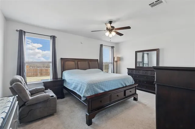 a bedroom with a bed couch and window