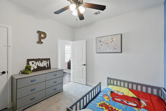 a bedroom with a bed and a dresser in it