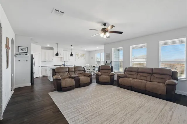 a living room with furniture and a chandelier