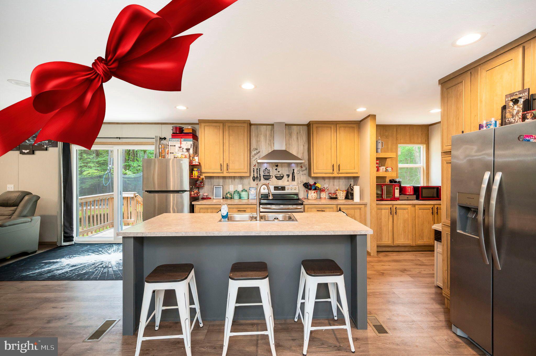 a kitchen with stainless steel appliances granite countertop a sink a stove and a refrigerator