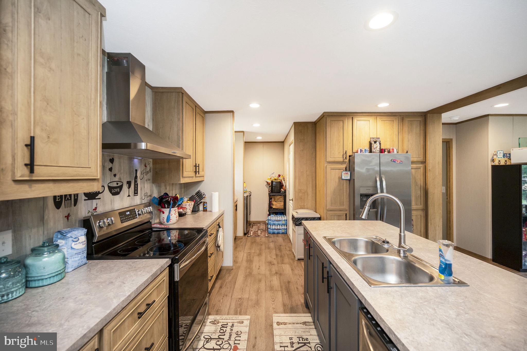 23066 Independence Road Unionville, VA 22567 - Photo 11 of 39 a kitchen filled counter top space a sink cabinets and a kitchen view