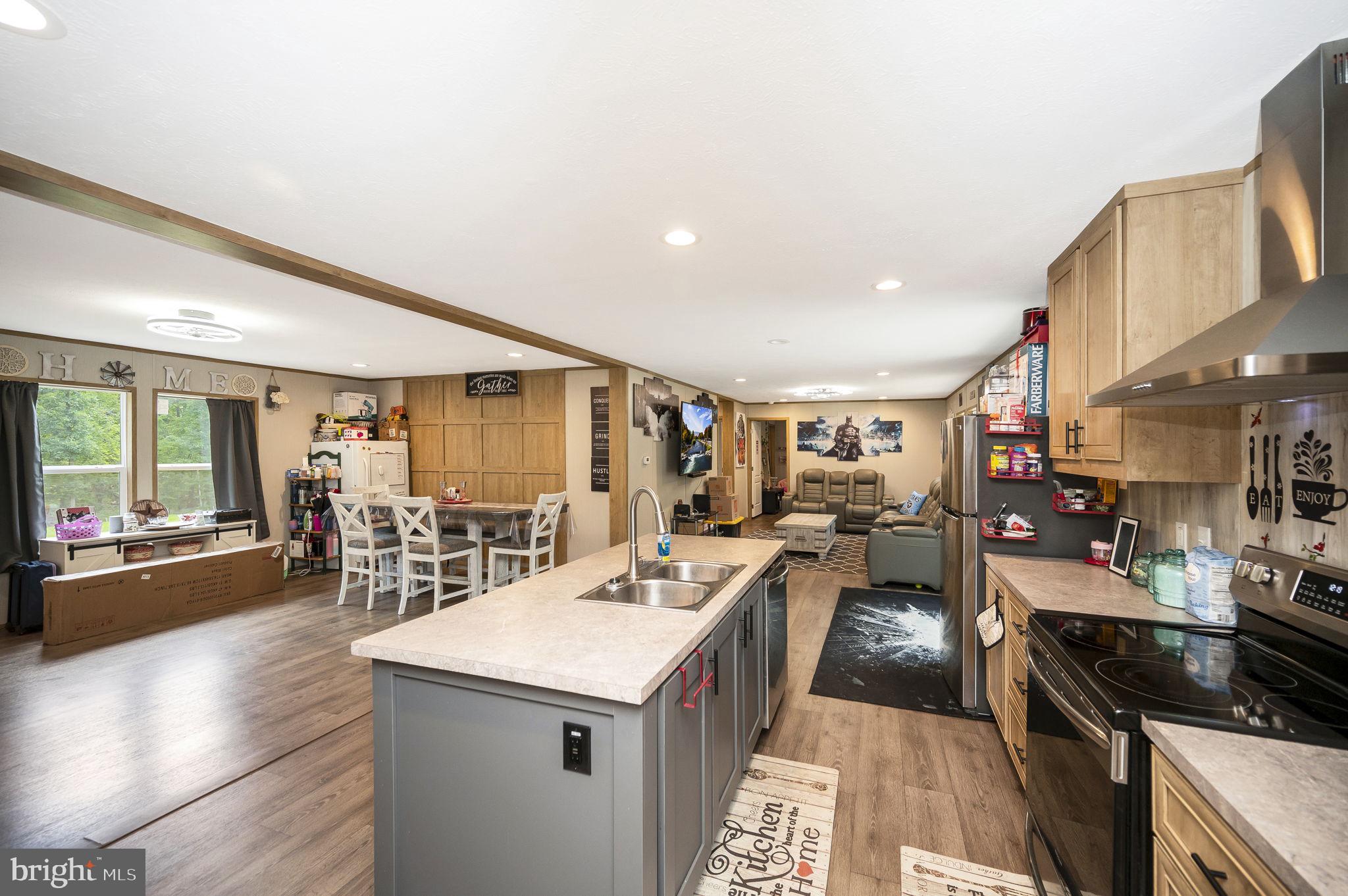 23066 Independence Road Unionville, VA 22567 - Photo 13 of 39 a kitchen with counter top space a sink a stove and cabinets