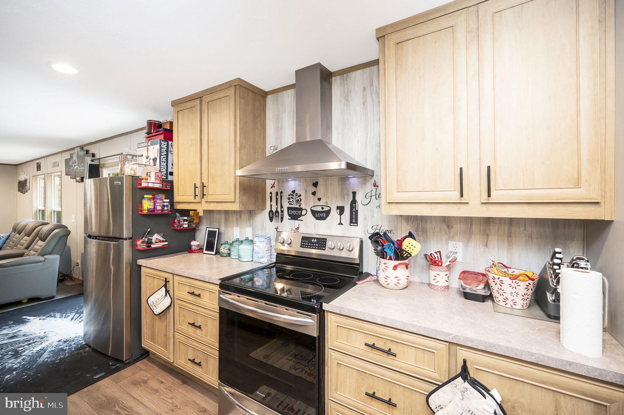23066 Independence Road Unionville, VA 22567 - Photo 14 of 39 a kitchen with stainless steel appliances granite countertop a sink stove and refrigerator