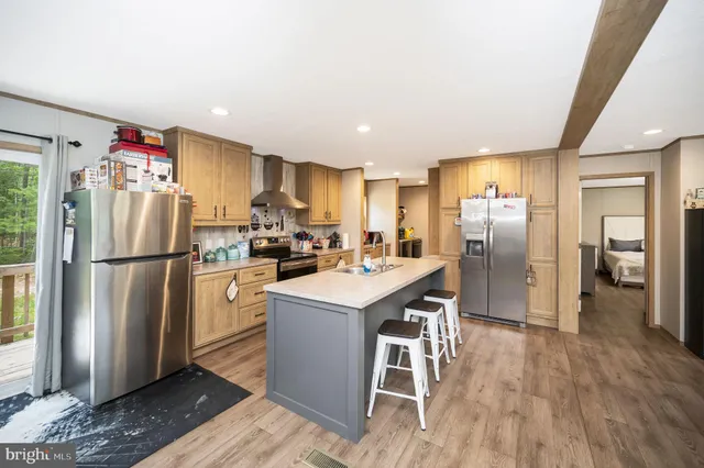 a kitchen with a refrigerator a sink and a stove