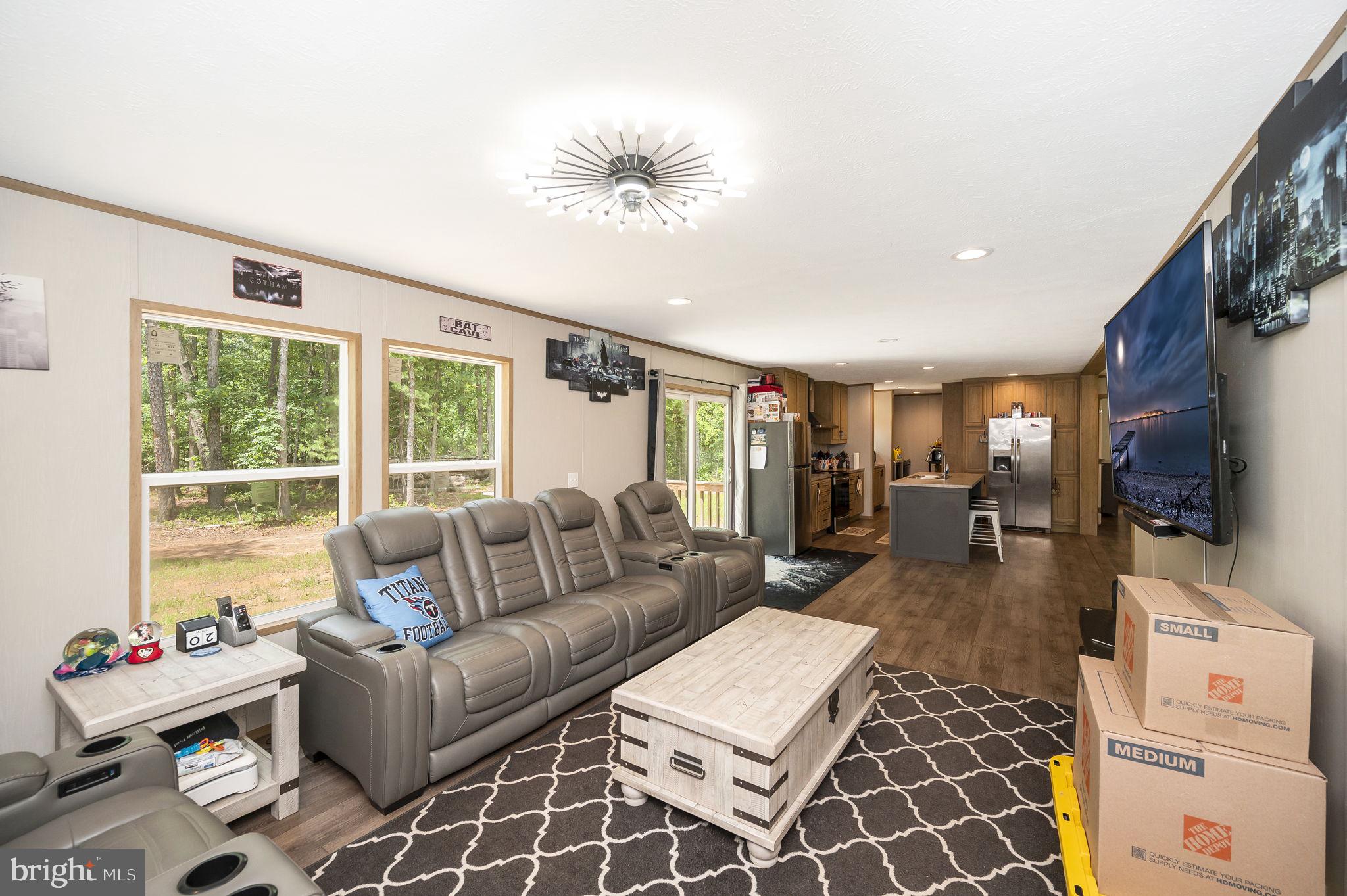 23066 Independence Road Unionville, VA 22567 - Photo 20 of 39 a living room with furniture a flat screen tv and a large window