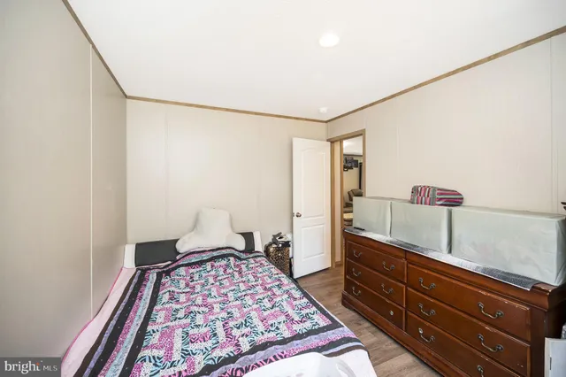 a bedroom with a bed and a dresser