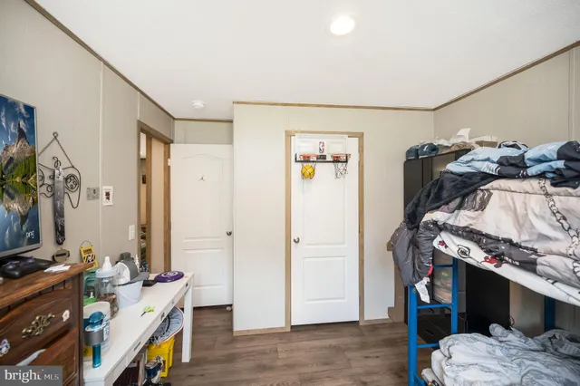 a view of bedroom with furniture and flat screen tv