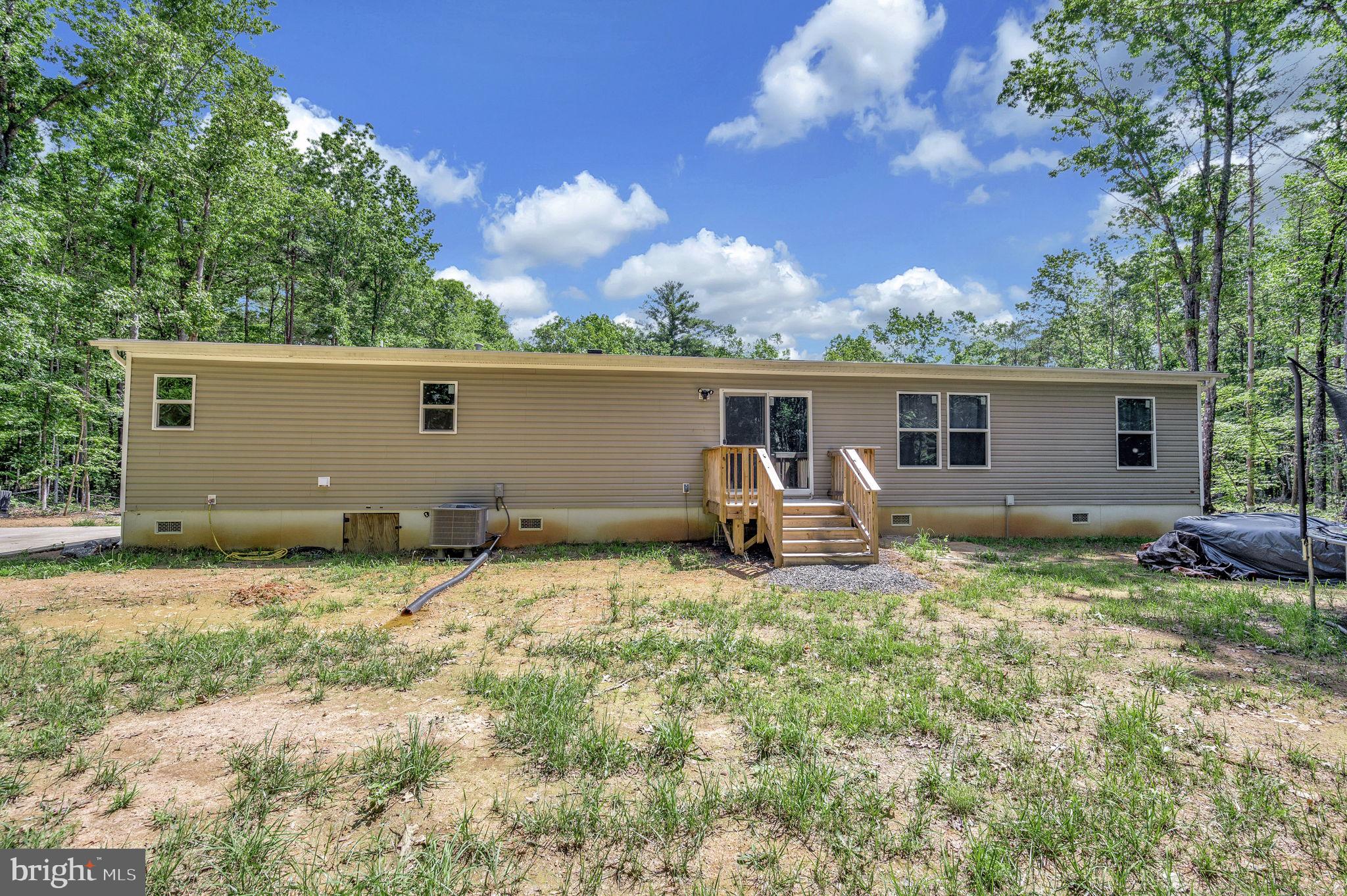 23066 Independence Road Unionville, VA 22567 - Photo 32 of 39 a backyard of a house with table and chairs