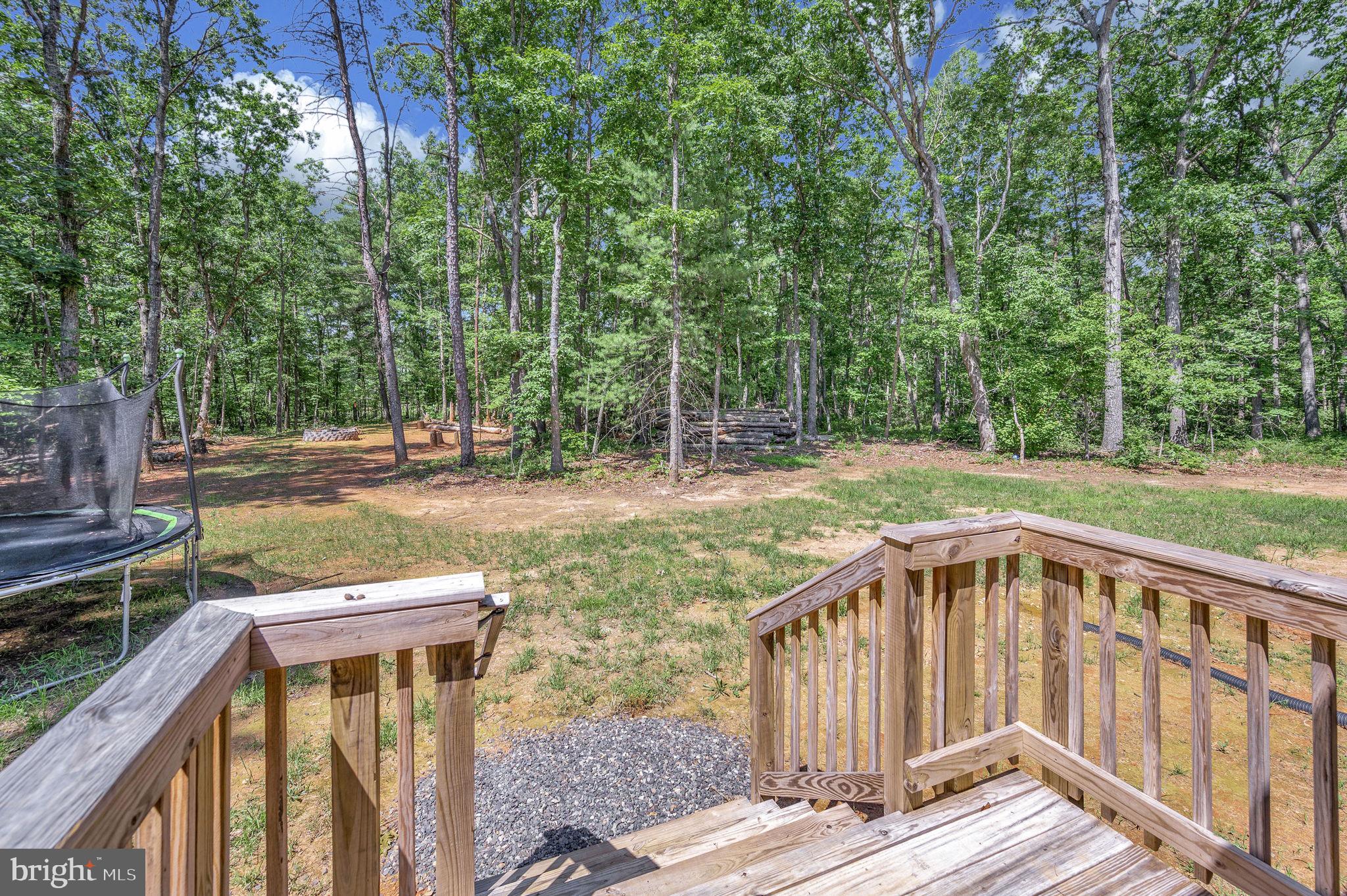 23066 Independence Road Unionville, VA 22567 - Photo 33 of 39 a view of a wooden deck with a yard