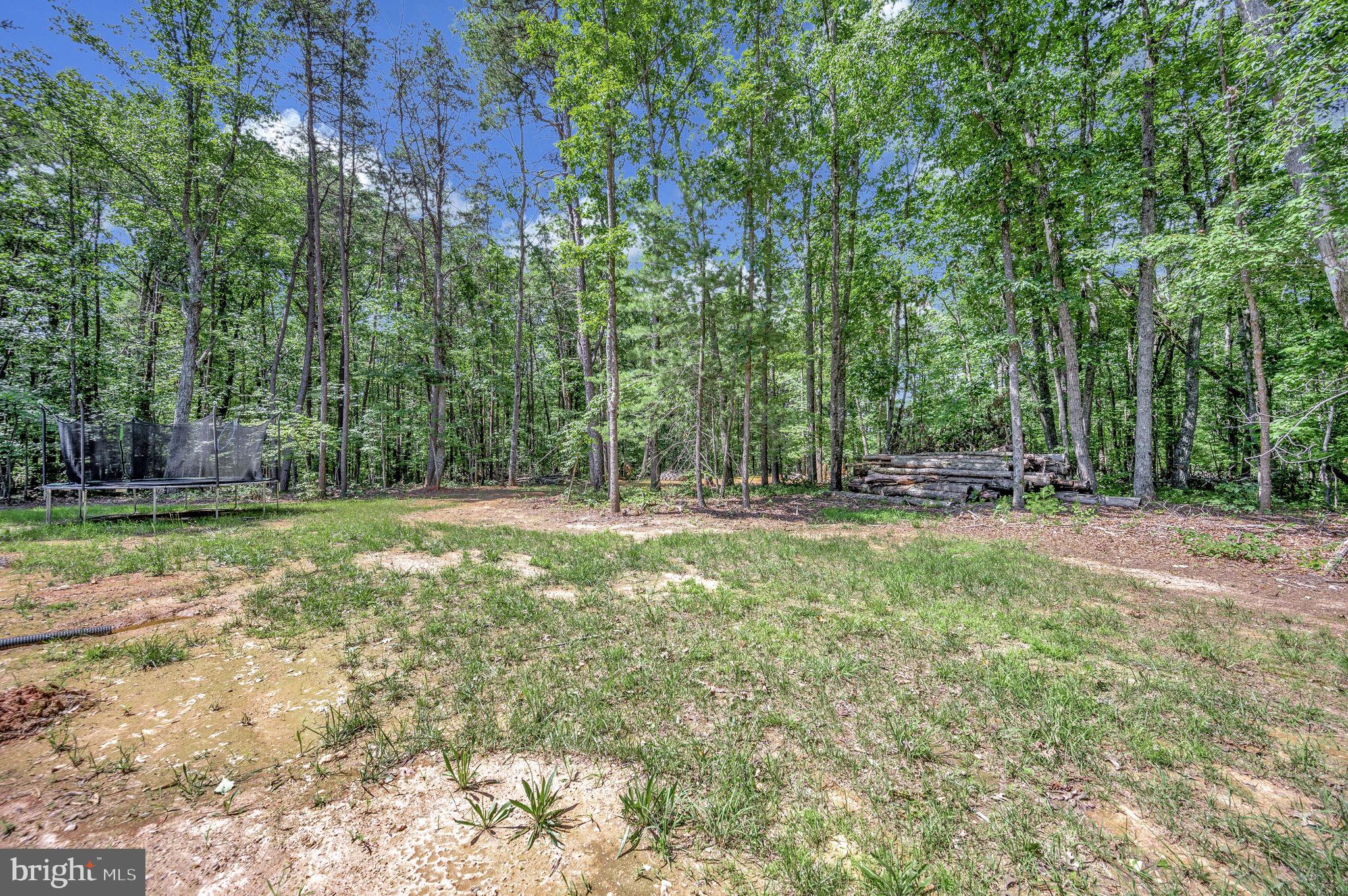 23066 Independence Road Unionville, VA 22567 - Photo 36 of 39 a backyard of a house with lots of green space and fountain