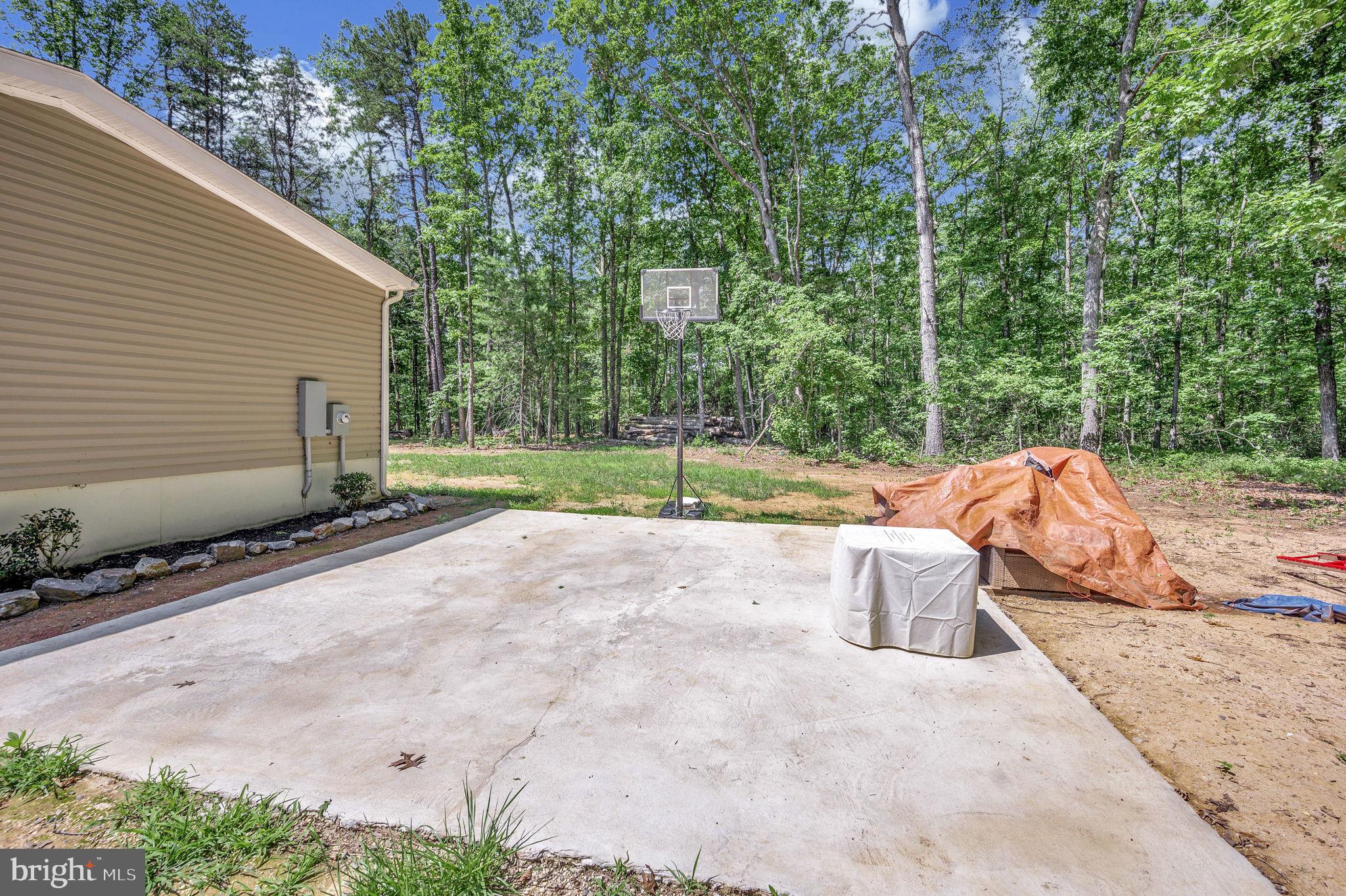 23066 Independence Road Unionville, VA 22567 - Photo 38 of 39 a backyard of a house with table and chairs