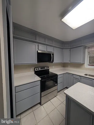a kitchen with a cabinets and white appliances