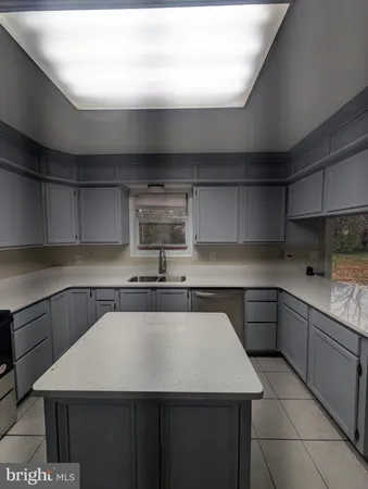 a kitchen with stainless steel appliances kitchen island granite countertop a sink and cabinets