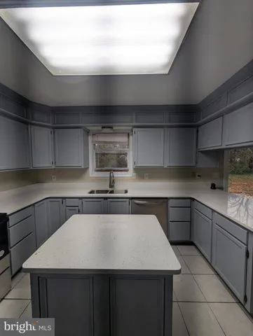 a kitchen with stainless steel appliances kitchen island granite countertop a sink and cabinets