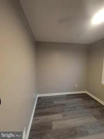 a view of an empty room and wooden floor