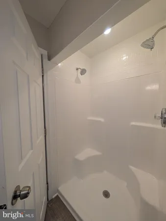 a white toilet sitting next to a bathroom sink and vanity