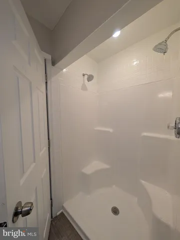 a white toilet sitting next to a bathroom sink and vanity