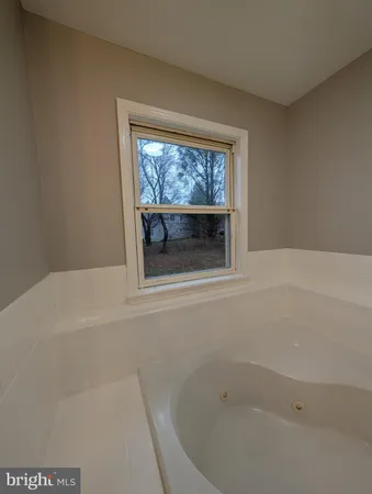 a bathroom with a bathtub and toilet