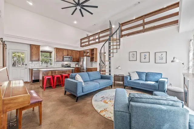 a living room with furniture and kitchen view