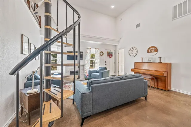 a living room with furniture and a stair