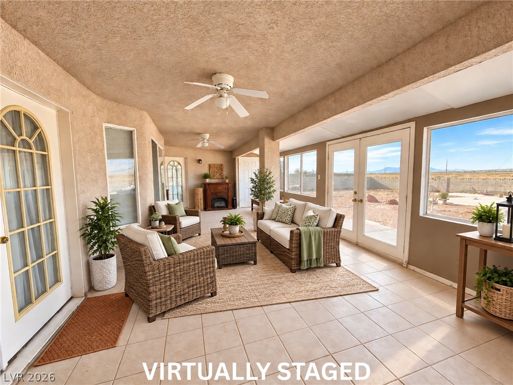 5470 Grain Mill Road Pahrump, NV 89061 - Photo 51 of 80 VIRTUALLY STAGED Tiled flooring and double doors define this versatile sunroom looking out to the desert landscape. This has so much potential, whatever you can dream of.