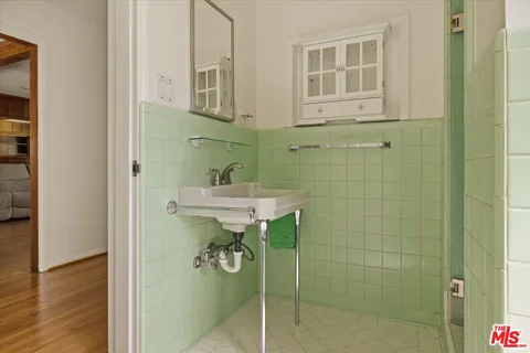 a bathroom with a sink a mirror and a shower