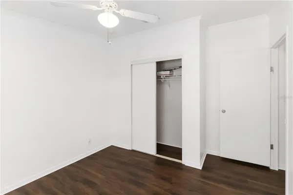 a view of an empty room with wooden floor