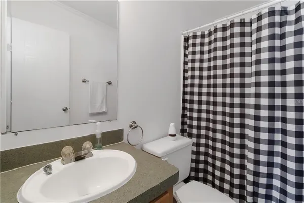 a bathroom with a sink toilet and a mirror